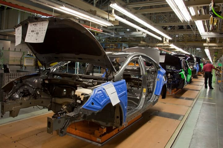Car bodies moving along a vehicle assembly line